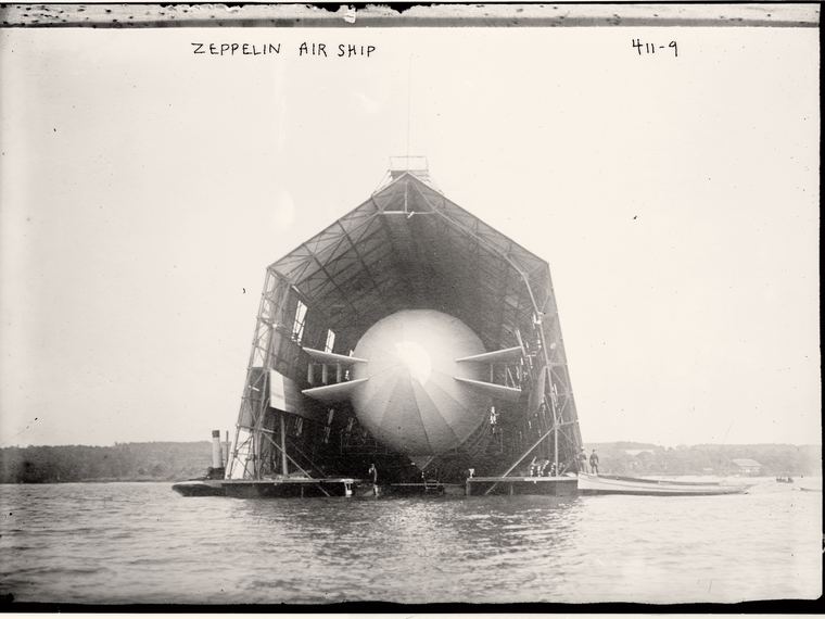 A zeppelin inside its floating hangar on the water, Zeppelin Air Ship handwritten along the top edge. Library of Congress ggbain.01956.
