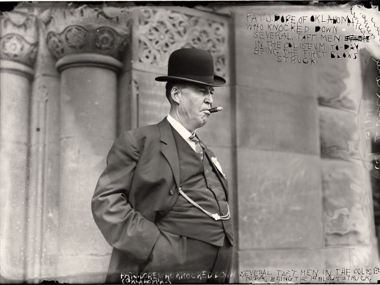 A man in a bowler hat beside a stone column, a dense handwritten caption block filling the upper right. Library of Congress ggbain.07023.