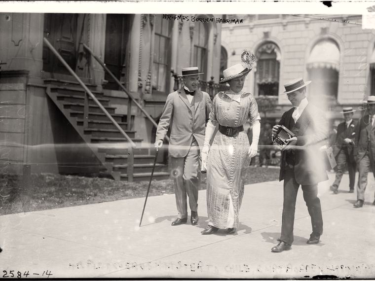Figures on a sidewalk, a faint handwritten caption running along the bottom edge. Library of Congress ggbain.07127.