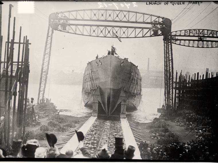 The battlecruiser Queen Mary going down the slipway at launch, the name in handwritten quote marks. Library of Congress ggbain.10459.