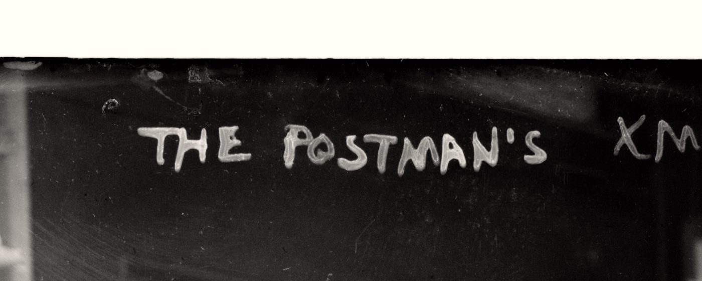 The handwritten caption The Postman's Xmas, source of the apostrophe