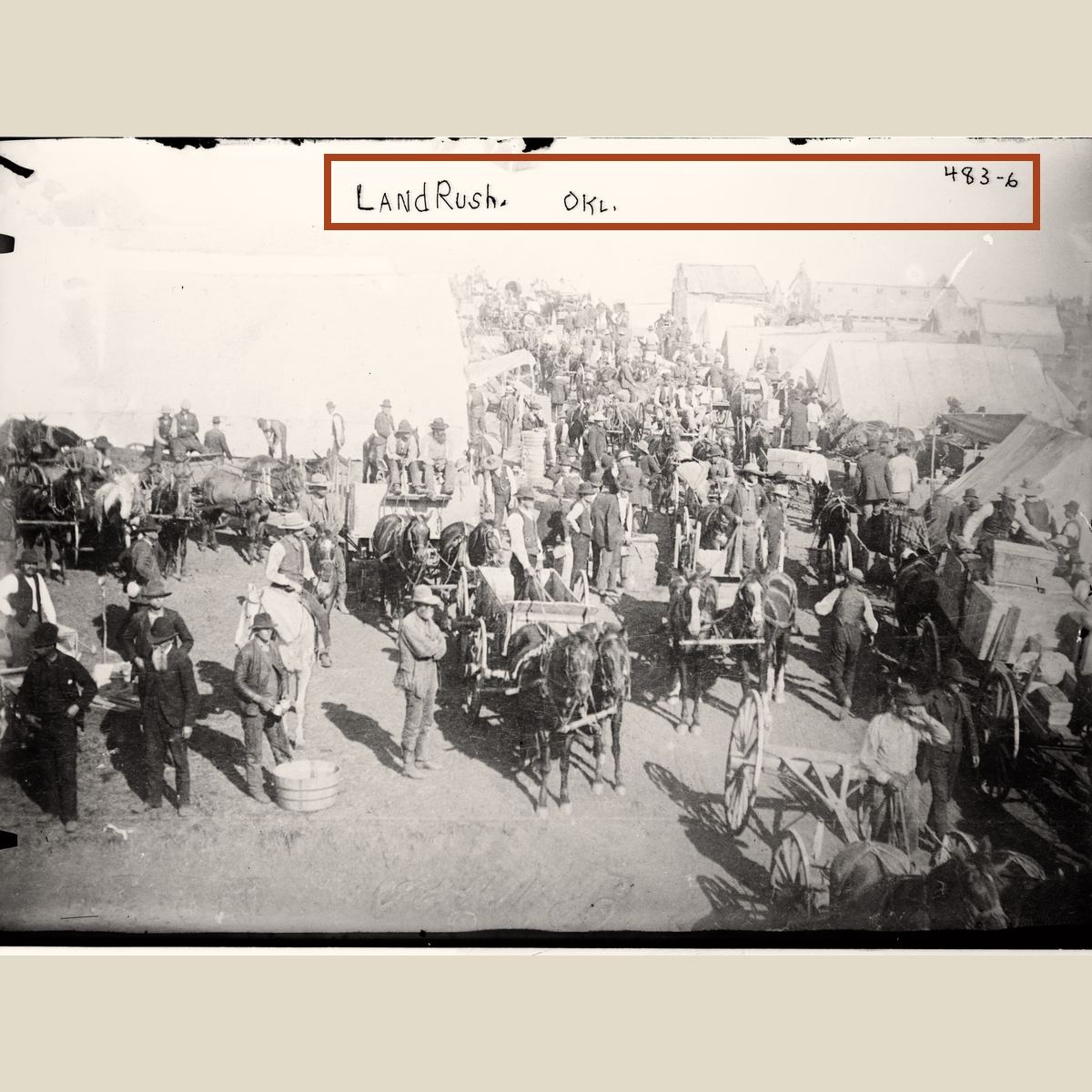 The full Land Rush glass negative with a rust rectangle marking the caption region in the sky